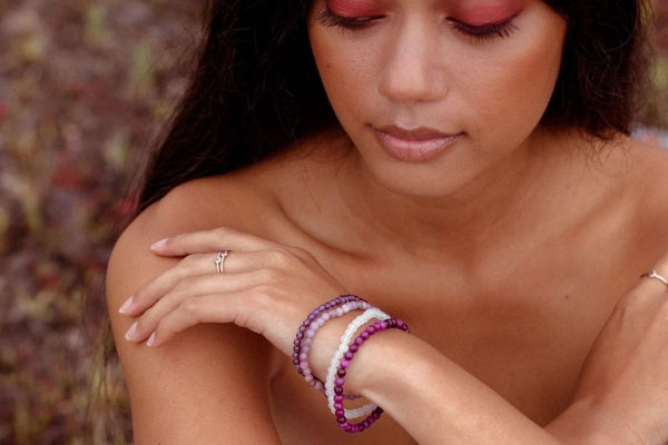 woman wearing gemstone bracelets
